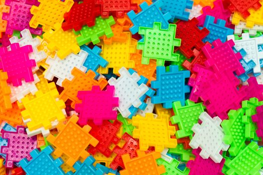 Some colorful jigsaw puzzle pieces close up.