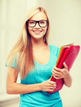 school and education concept - smiling student with folders