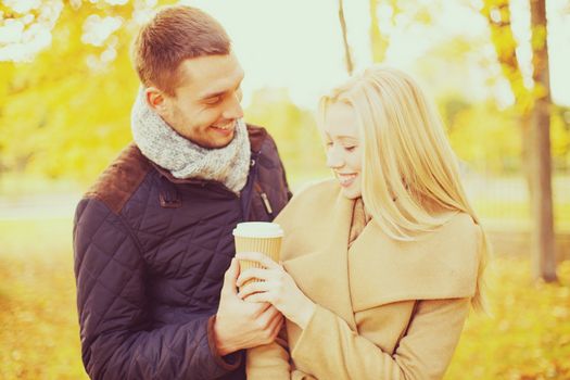 holidays, love, travel, relationship and dating concept - romantic couple in the autumn park