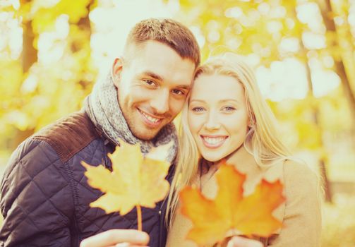 holidays, love, travel, relationship and dating concept - romantic couple in the autumn park