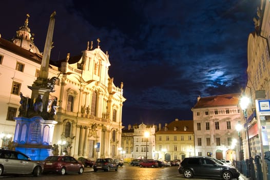 Street at night in Prague with church.