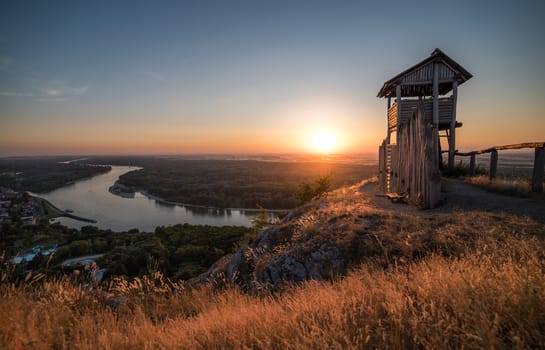 Wooden Tourist Observation Tower above a Little City of Hainburg an der Dounad with Danube River at Beautiful Sunset