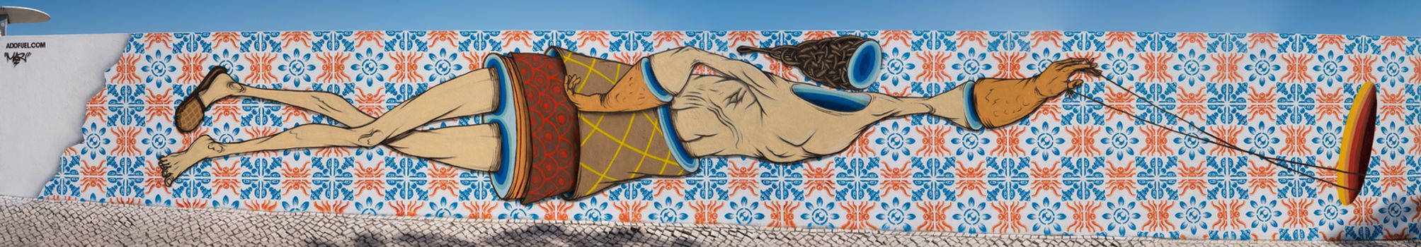 OVAR, PORTUGAL - AUGUST 10, 2015: Wall one panorama with painted Azulejo tiles by graffiti artists Add Fuel and gonçaloMAR during Festa'15 festival in 2015.