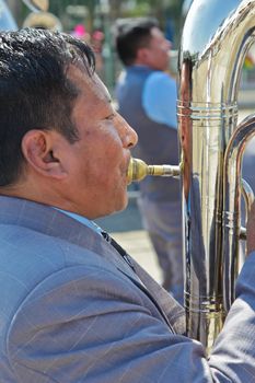 SAO PAULO, BRAZIL August 9 2015: An unidentified man with typical costumes playing a typical music instrument during the Morenada parade in Bolivian Independence Day celebration in Sao Paulo Brazil.