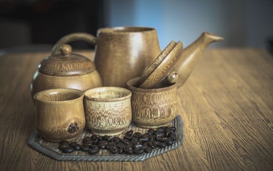 Vintage photo of coffee beans and Coffee cups set on wooden background.Vintage style.