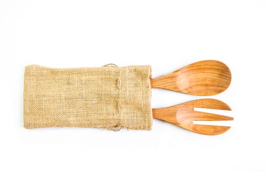 Wooden spoon and fork on sack surface.Isolated on white background.