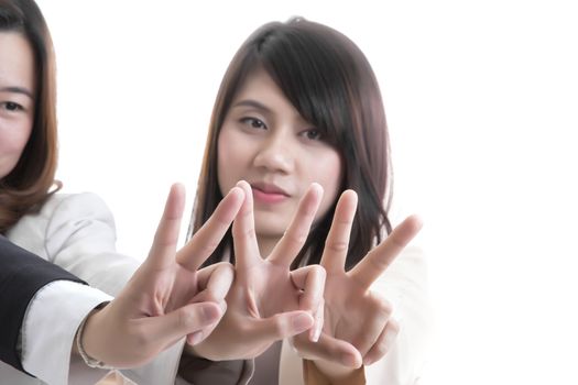 Two asian business in office, showing two fingers or victory gesture on white background