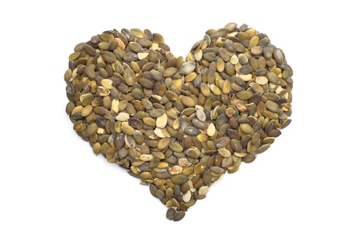 Pumpkin seeds in a heart shape, isolated on a white background