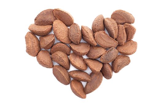 Brazil nuts in a heart shape, isolated on a white background
