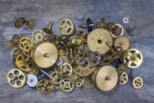 Selection of dusty old brass clock parts.