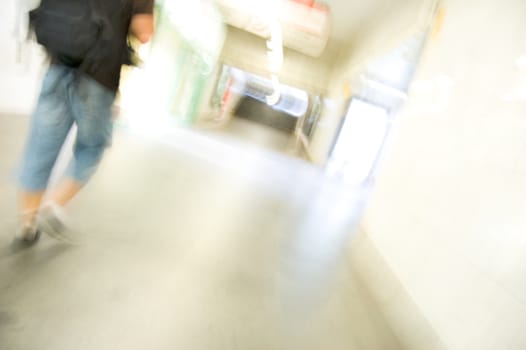 Hurrying man in the subway corridor. Color version. Abstract picture.