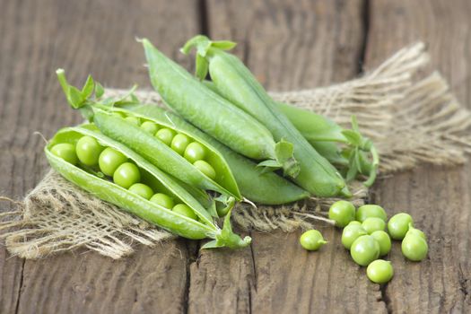 green peas on wooden background