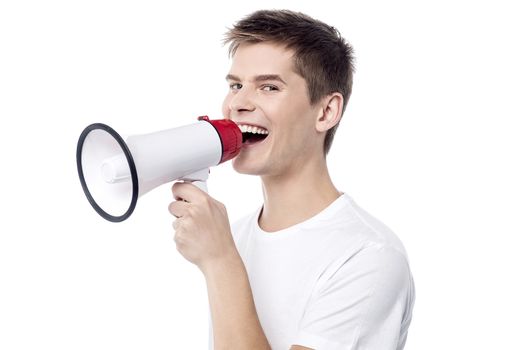 Young man proclaiming into megaphone