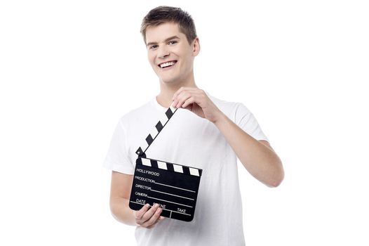 Cheerful young male with open film slate 