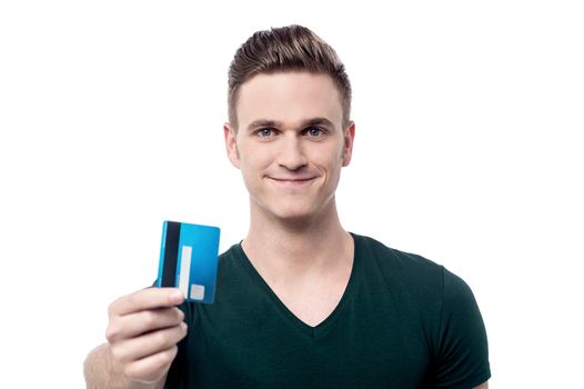 Young man showing debit card to camera