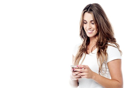 Cheerful woman messaging via her phone