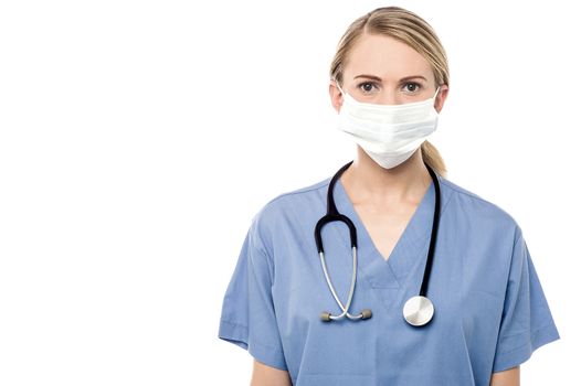 Female surgeon posing with surgical mask over white