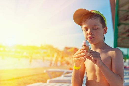 Baby boy with ice-cream at the beach