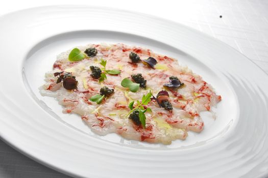 Fish Appetizer Carpaccio of Red Prawns and Caviar in white round plate