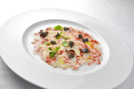 Fish Appetizer Carpaccio of Red Prawns and Caviar in white round plate