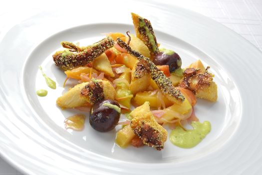 Fish Dish Fried Octopus with marinated Fruit on white roud plate 