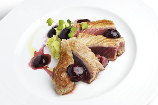 Fish Dish Tuna Fillet with Cherries in port and Mashed Potatoes in white plate