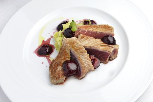 Fish Dish Tuna Fillet with Cherries in port and Mashed Potatoes in white plate