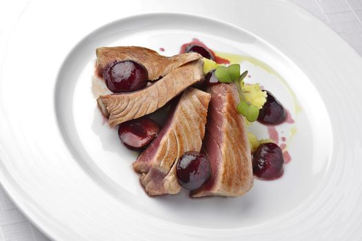 Fish Dish Tuna Fillet with Cherries in port and Mashed Potatoes in white plate