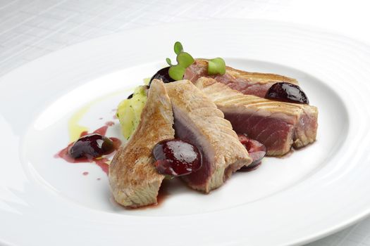 Fish Dish Tuna Fillet with Cherries in port and Mashed Potatoes in white plate