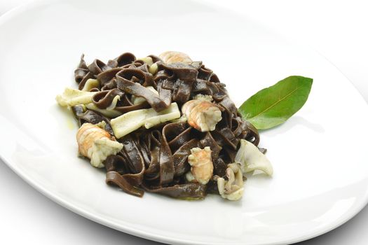 Pasta Dish Chocolate Fettuccine with Prawns and Cuttlefish in white plate