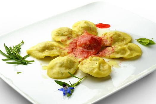 Pasta Dish Ravioli Stuffed with Shellfish and Sauce Wild Berries in square white plate