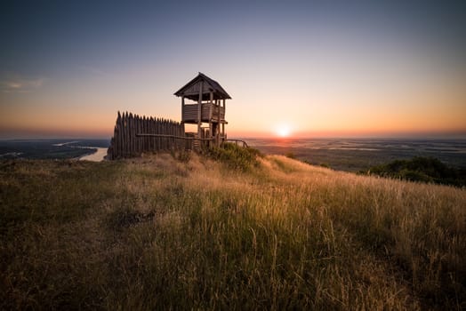 Wooden Tourist Observation Tower over a Landscape at Beautiful Sunset