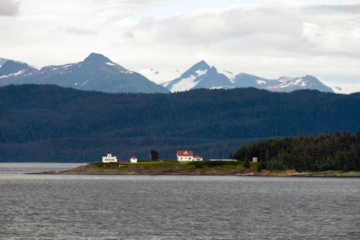 A marine highway ferry boat passes a nautical beacon on the inside passage