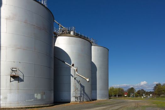 Large silos on a clear day, with drop pipe showing.