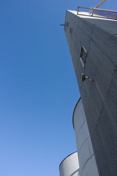 Shot of large steel silos. Clear Skies.