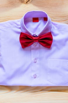 pink shirt for a boy with a red butterfly