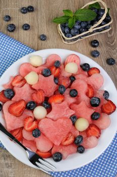 salad of blueberries, watermelon hearts, stars, balls of melon and strawberries