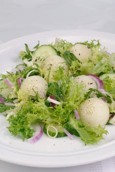 Arugula salad with cucumber with melon balls