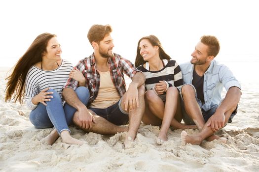 Multicultural group of friends at the beach having fun