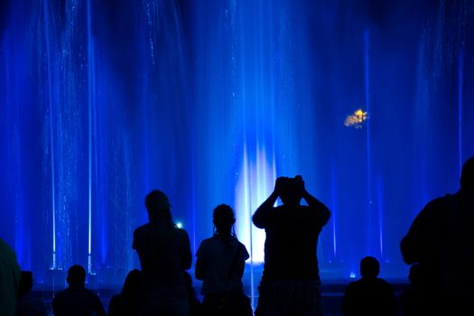 People wondering colourful fountain in Budapest, Hungary