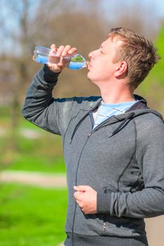 a young man with a bottle of water