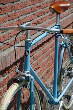 Milano, Italy - June 30, 2013: A luxury vintage Italian fixed-gear (fixie) bike in sky blue with leather saddle and grips and white tubes.
