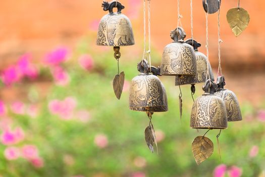 Detail view of vintage bronze bells with nice colorful bokeh