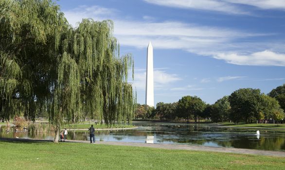 WASHINGTON, D.C. - OCTOBER 17, 2014: People enjoy sunny day at the Washington Monument. It is an obelisk built to commemorate George Washington.