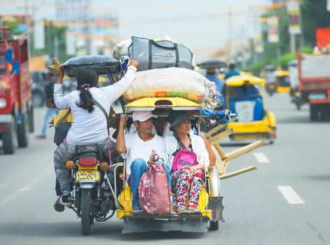 Koronadal City, The Philippines - August 6, 2015: Throughout The Philippines, the tricycle is a popular way of transportation, used for bringing children to school as well as journeys with luggage.