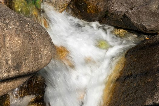 Detail of water flowing over the rocks. Long time exposure