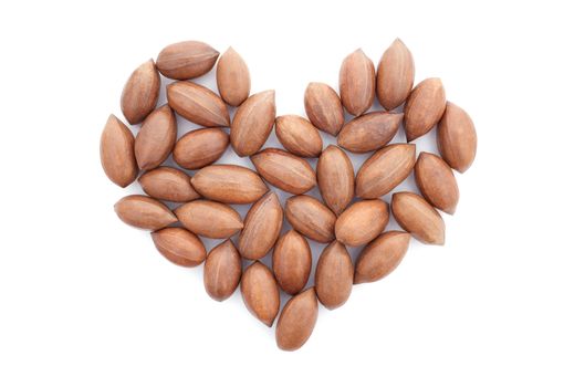 Pecan nuts in a heart shape, isolated on a white background