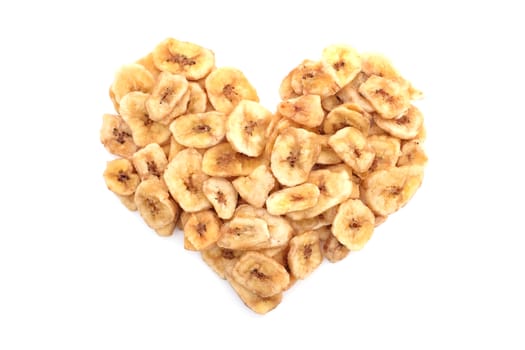 Dried banana chips in a heart shape, isolated on a white background