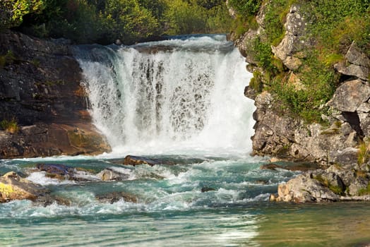 Waterfall in summer, Chiese River, in the National Park of Adamello Brenta, Val di Fumo. Trentino Alto Adige, Italy
