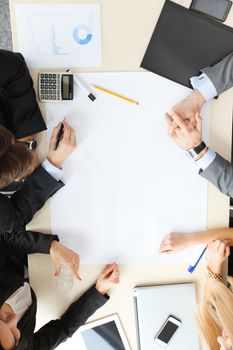 Business people sitting at table with electronic devices on meeting